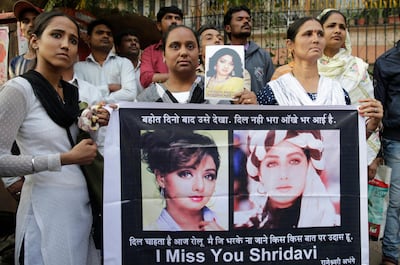 Fans of Bollywood actress Sridevi hold posters as they wait outside her home to pay their last respects in Mumbai on Wednesday morning. Dubai police on Tuesday closed the case into the death last weekend of Indian movie icon Sridevi, calling it an accidental drowning in a bathtub at Jumeirah Emirates Towers hotel. Rafiq Maqbool / AP Photo
