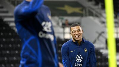 France's forward Kylian Mbappe smiles during a training session. AFP