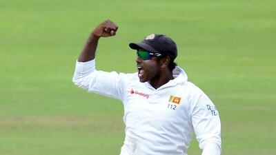 Sri Lankan captain Angelo Mathews celebrates with the stumps after victory in the opening Test match between Sri Lanka and Australia at the Pallekele International Cricket Stadium in Pallekele on July 30, 2016. AFP / LAKRUWAN WANNIARACHCHI