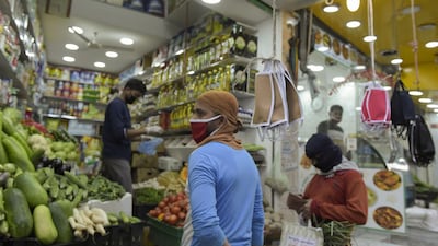 A grocery store displays protective masks for sale amid the Covid-19 pandemic in the old marketplace of the Bahraini capital Manama. AFP