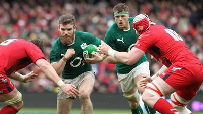 Ireland centre Gordon D'Arcy, second from left, is tackled by Wales' Jake Ball during the Six Nations international rugby union match at the Aviva Stadium in Dublin on Saturday. PETER MUHLY / AFP