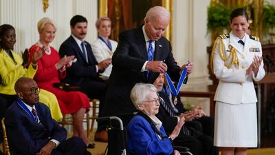Mr Biden awards retired Brig Gen Wilma Vaught at the White House ceremony. AP