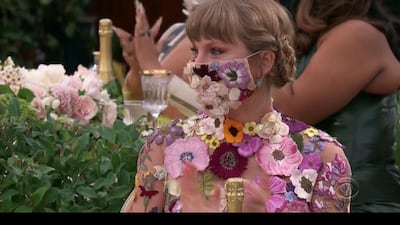 Taylor Swift paired her flowery mini dress designed by Oscar de la Renta with a matching mask. REUTERS