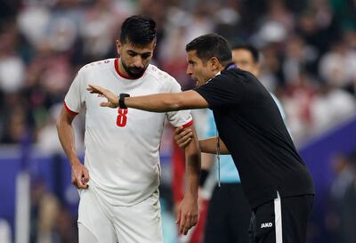 Jordan coach Hussein Ammouta talks to Noor Al Rawabdeh during the match. Reuters