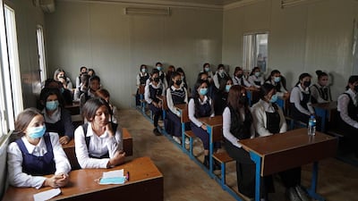 Yazidi girls sit in class on the first day of school at a displaced persons camp in the Sharya area, about 15 kilometres from the city of Dohuk in Iraqi Kurdistan. AFP