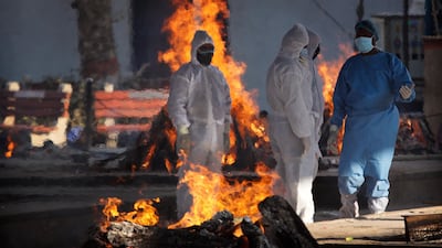 Health workers and relatives stand by the funeral pyre of a COVID-19 victim in New Delhi, India. India’s total number of coronavirus cases since the pandemic began has crossed 9 million. Nevertheless, the country’s new daily cases have seen a steady decline for weeks now and the total number of cases represents 0.6% of India’s 1.3 billion population. AP Photo