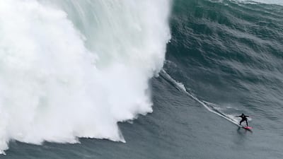 Justine Dupont from France rides a wave during a tow surfing session at Praia do Norte in Nazare, Portugal, on Saturday, February 15. AP
