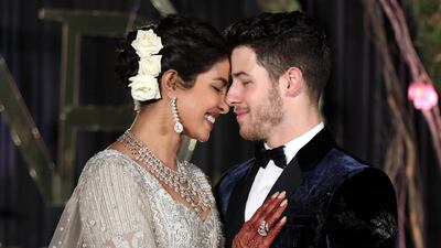 Newlyweds Priyanka Chopra, 36, and Nick Jonas, 26, pose for a photograph during a reception at a hotel in New Delhi on December 4, 2018. Photo: EPA