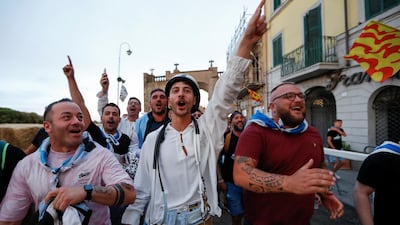 Supporters of the Fontana Grande parish in Ronciglione celebrate after their horse wins the event.