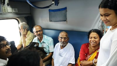 Indian monk Swami Sivananda, centre, who claims to be 120 years old, sits with followers on board a train from Howrah station on his way to Varanasi from Kolkata. All photos by Dibyangshu Sarkar / AFP