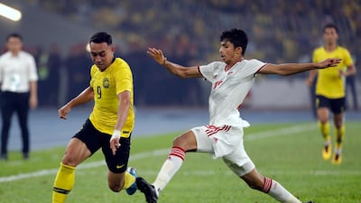 UAE's Mohammed Al Attas, right, challenges Norshahrul Idlan of Malaysia. AP