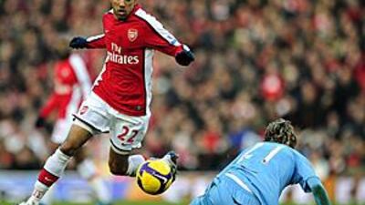 Arsenal's Gael Clichy, left, goes past West Ham United's Valon Behrami.