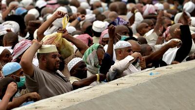 Muslim pilgrims cast stones at a pillar, symbolizing the stoning of Satan near the Saudi holy city of Mecca, Saudi Arabia. Hassan Ammar / AP Photo