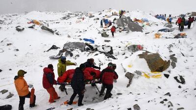 This file photo taken by Agence France-Presse (AFP) photographer Roberto Schmidt on April 25, 2015 shows rescuers using a makeshift stretcher to carry an injured person after an avalanche triggered by an earthquake flattened parts of Everest Base Camp. AFP’s veteran lensman Roberto Schmidt on February 18, 2016 won second prize at the prestigious World Press Photo Award in the Spot News stories category, for his dramatic shots of the deadly avalanche on Mount Everest triggered by last April’s Nepal earthquake. Roberto Schmidt / AFP Photo