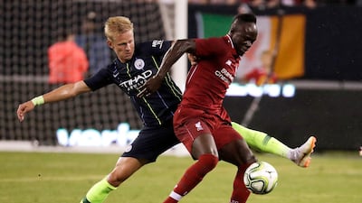 Liverpool's Sadio Mane tries to control the ball as Manchester City's Oleksandr Zinchenko defends. AP Photo
