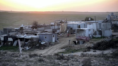 Homes made of corrugated tin - with solar panels and the networks of pipes that provide water visible - are seen in Al Poraa on February 4, 2018. Heidi Levine