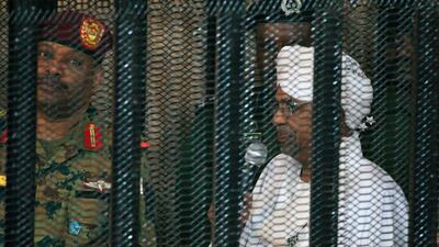 Sudan's deposed military ruler Omar Al Bashir stands in the defendant's cage during the opening of his trial for corruption in Khartoum in August 2019. AFP