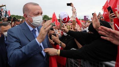 Turkish President Recep Tayyip Erdogan greets his supporters as he arrives at the ground-breaking ceremony of Sazlidere Bridge over the planned route of Istanbul Canal on June 26, 2021. Reuters