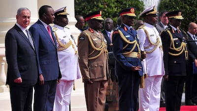 Israeli prime minister Benjamin Netanyahu, left, with Kenya’s president Uhuru Kenyatta, second left, and officials, at the state house in Nairobi in July. Questions have been asked about Mr Netanyahu’s bid to strengthen ties with African countries. Simon Maina / AFP
