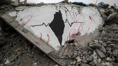 The debris from a destroyed home in Deir Al Balah becomes a canvas for a mural painted by a Palestinian artist. EPA