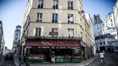 A man passes by the grocery store 'La Maison Collignon', known for appearing as a movie set in the French film 'Amelie' in Paris, France. EPA