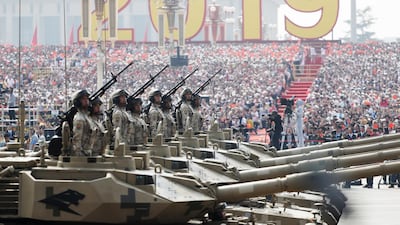 Chinese troops on tanks roll past Tiananmen Square. EPA