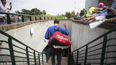 Roger Federer waves to fans as he leaves a training session on Monday ahead of his first round match at Wimbledon 2015 on Tuesday. Peter Klaunzer / EPA