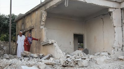 Residents inspect the damage following air strikes on the Syrian town of Muhambal in Idlib province on July 6, 2019. AFP