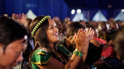 A dignitary dressed in the colours of the African National Congress applauds as the final results are announced at the results ceremony at the Independent Electoral Commission Results Center in Pretoria, South Africa Saturday, May 11, 2019. South Africa's ruling African National Congress on Saturday marked its weakest victory in national elections in a quarter-century. AP Photo