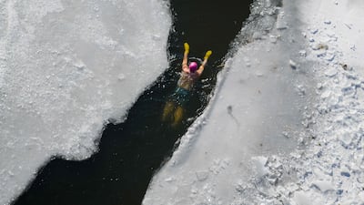 A swimmer negotiates a channel in the ice during a winter swimming event at Shenshuiwan Park in Shenyang, in north-eastern China's Liaoning province. AFP
