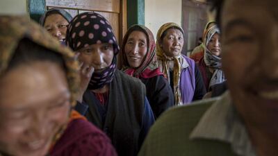 Ladkahi women wait at a polling station to vote near the Thiksey Monastery.