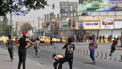 Iraqi protesters hurl stones at security forces amid clashes following an anti-government demonstration in Iraq's southern city of Nasiriyah in Dhi Qar province. AFP