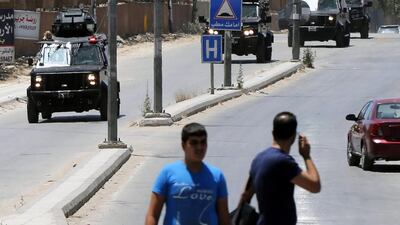 Jordanian Special Forces vehicles pass near an Intelligence office near Baqa'a refugee camp north of Amman. EPA