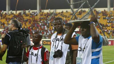Members of the media take cover after Equatorial Guinea fans threw objects during their African Nations Cup semi-final soccer match against Ghana in Malabo February 5, 2015. Violent scenes overshadowed the African Nations Cup semi-final as Ghana reached Sunday?s final with a 3-0 win over hosts Equatorial Guinea on Thursday in a match halted for 34 minutes late in the second half. REUTERS/Amr Abdallah Dalsh