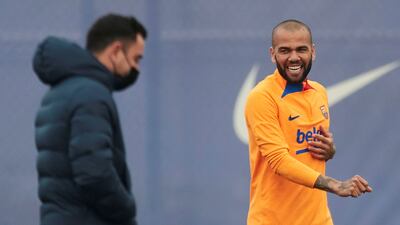 Barcelona manager Xavi Hernandez with defender Dani Alves during the team's training session. EPA