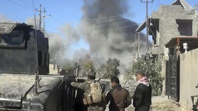 Smoke rises from ISIL positions following a US-led coalition air strike as Iraqi security forces advance in central Ramadi on December 25, 2015. AP Photo