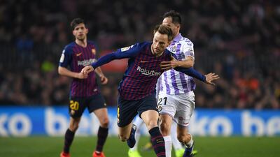 Barcelona's Ivan Rakitic is challenged by Real Valladolid's Michel. Getty Images