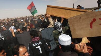 Opposition supporters carry coffins during a funeral for slain rebel fighters in Ajdabiya, Libya.