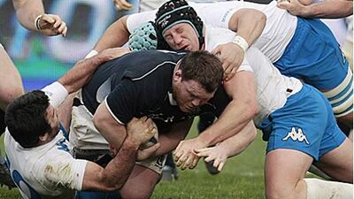 Scotland's Allan Jacobsen, centre, is handled up by the Italian defence.
