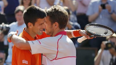 Stan Wawrinka, right, of Switzerland hugs Novak Djokovic of Serbia after winning their men's final match at the French Open tennis tournament at the Roland Garros stadium in Paris, France, June 7, 2015. REUTERS/Vincent Kessler