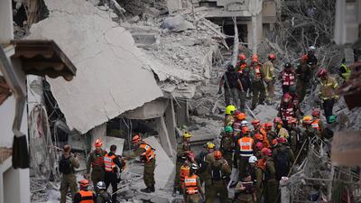 Damage assessments in daylight at Rishon LeZion after a wave of Iranian missiles hit. AP Photo