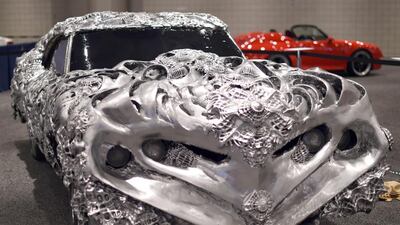Artist Ioan Florea transformed the Gran Torino into a 3D piece of art by covering the car in a new metal surface with printed appliques. Timothy Clary / AFP