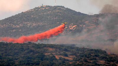 A firefighting plane tries to extinguish a forest fire near the Israeli military base of Har Dov on Mount Hermon, a strategic and fortified outpost at the crossroads between Israel, Lebanon, and Syria. AFP