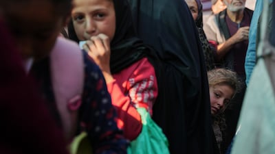 Palestinians wait to receive food at a community kitchen in Deir Al Balah, central Gaza. AP