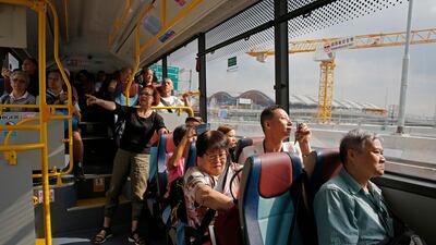 Passengers take the shuttle bus to cross the China-Zhuhai-Macau-Hong Kong Bridge during the first day operation of the world's longest cross-sea project. AP Photo