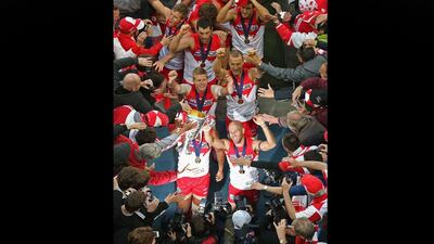 Swans co-captains Jarrad McVeigh and Adam Goodes walk down the players' tunnel with the Premiership Cup after winning the 2012 AFL Grand Final match against the Hawthorn Hawks at Melbourne Cricket Ground. Scott Barbour / Getty Images