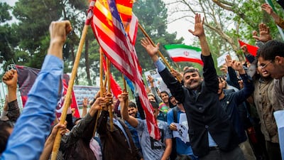 Iranians wave flags during an anti-US demonstration. Ali Mohammadi / Bloomberg