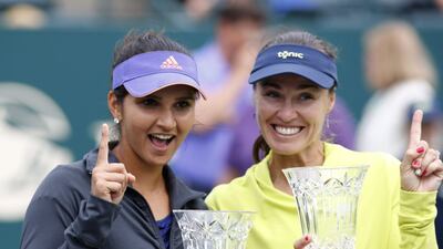 Sania Mirza, left, alongside doubles partner Martina Hingis after winning the Family Circle Cup in 2015 that propelled her to No1 in doubles rankings. AP