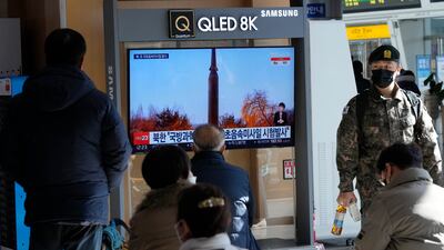 People watch TV at the Seoul Railway Station after North Korea's missile launch. AP