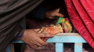 Relatives the bride say goodbye as she leaves her house.